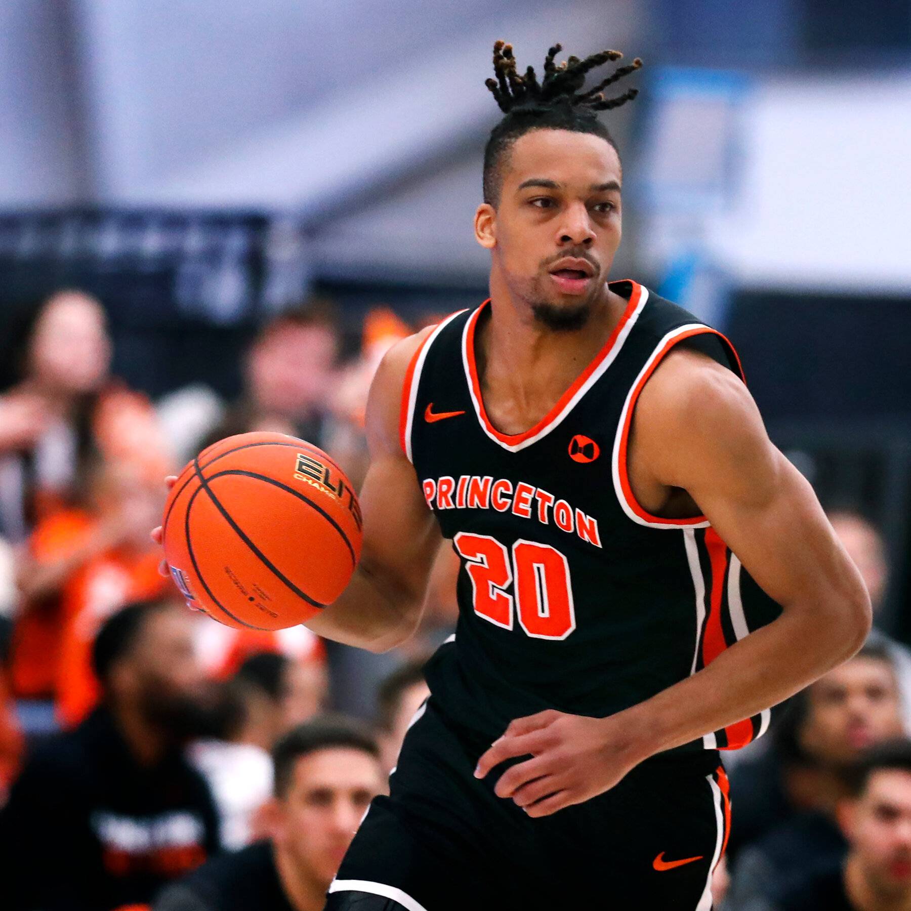 Princeton men's basketball squad wearing their full orange and black uniforms