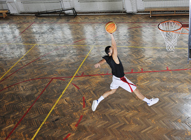 young and healthy people man have recreation and training exercise  while play basketball game at sport gym indoor hall