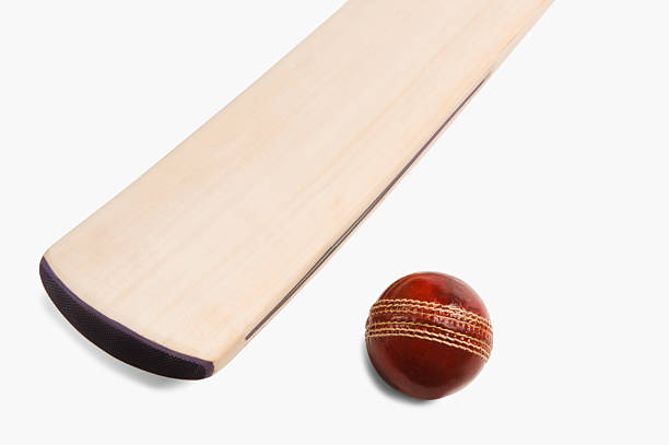 Close-up of a cricket ball with a bat