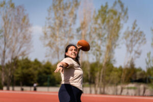 girls playing an intense game of rugby on the field with their friends