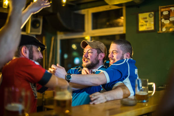 Angry soccer fans of two rival teams fighting in sports bar